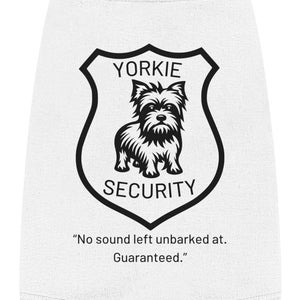 May include: White dog t-shirt with a black Yorkshire Terrier silhouette inside a shield with the text "Yorkie Security" and the quote "No sound left unbarked at. Guaranteed."