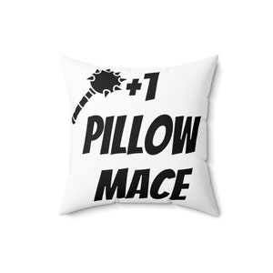 May include: White pillow with black text that reads "#1 Pillow Mace" and a black silhouette of a spiked mace.