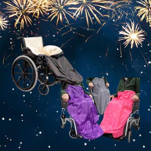 May include: A wheelchair with a black cover and three other wheelchairs with purple, grey, and pink covers. The background shows a dark blue sky with fireworks.