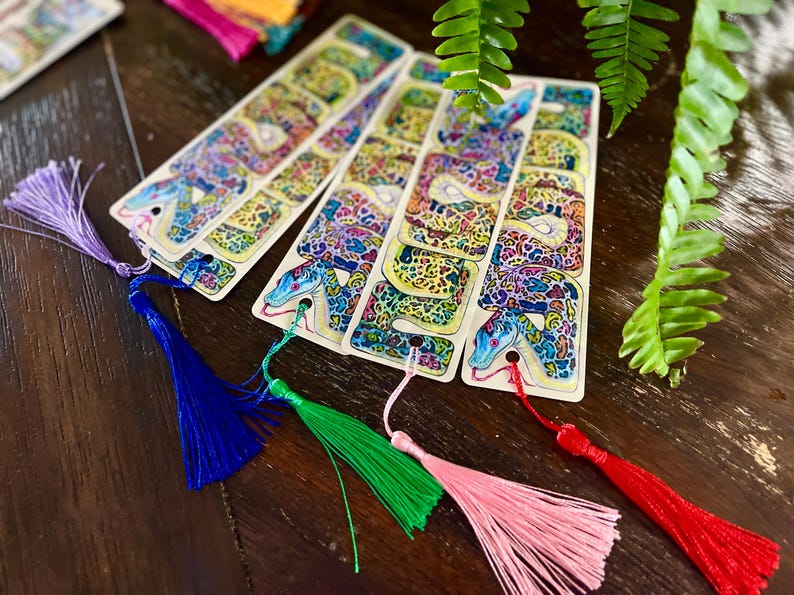 May include: Five colourful bookmarks with a snake design. Each bookmark has a different coloured tassel.