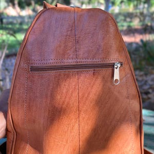 the back side of a womens backpack, rucksack,zipped pocket