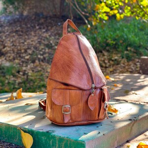 the side of Brown handmade leather backpack, womens backpack, leather Rucksack, 2 pockets on the front, Zipped pockets, adjustable zipped pockets