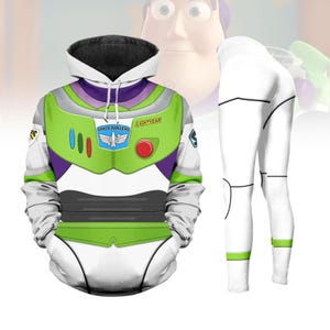 Puede incluir: Un conjunto de sudadera con capucha y leggings de Buzz Lightyear. La sudadera es blanca, verde y morada, con el logo de Space Rangers y el texto "Lightyear". Los leggings son blancos con rayas verdes en los tobillos. Inspirado en el personaje de Toy Story.
