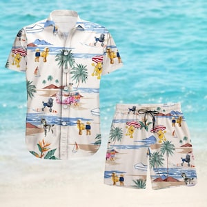 May include: A white and blue patterned button-up shirt and matching shorts featuring cartoon dogs and palm trees. The shirt has a short sleeve and a button-up collar. The shorts have an elastic waistband and a drawstring.