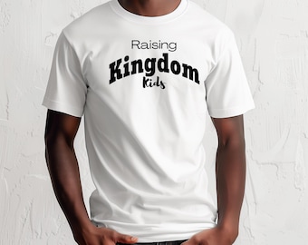 May include: White t-shirt with the text "Raising Kingdom Kids" in black. The word "Kingdom" is in a bold, stylized font. The shirt has short sleeves and a crew neck.
