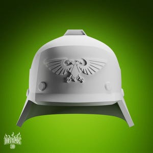 May include: A white helmet featuring an eagle emblem. The helmet has a rounded top, a visor, and circular details on the sides. The background is a solid green. The helmet is likely a 3D printed model.
