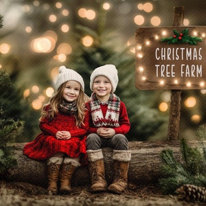 May include: Two children wearing white knit hats and winter clothing sit on a log in front of a sign that reads "Christmas Tree Farm". The sign is decorated with string lights and a sprig of greenery.