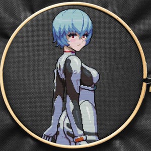 May include: Cross-stitch embroidery of a blue-haired anime character wearing a white and black suit. The character has red eyes and a serious expression.