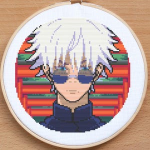 May include: Cross-stitch embroidery of a white-haired anime character wearing sunglasses against a red and green background.