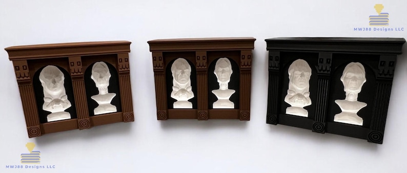 May include: Three decorative wall plaques with a brown, black, and white finish. Each plaque features two white busts in a recessed alcove with a decorative frame.