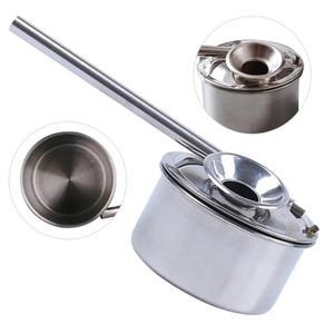 May include: A stainless steel pouring pot with a long spout and a funnel-shaped lid. The pot is designed for pouring liquids, such as honey or syrup, with precision.