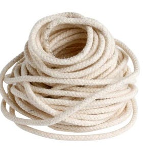 May include: A coiled bundle of off-white rope, tightly wound and textured. The rope appears to be made of a natural fiber, with a consistent thickness throughout. The image is set against a plain white background.