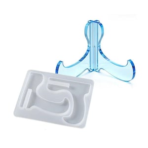 May include: A clear blue acrylic display stand with a three-pronged base and a white silicone mold with a number 5 shape. The stand is designed to hold items, and the mold is for creating resin art.
