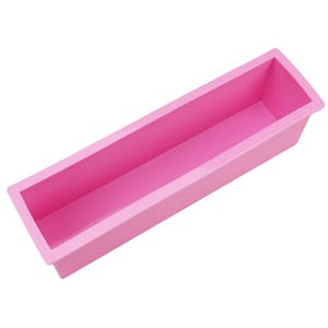 May include: A rectangular, bright pink silicone mould with a smooth interior and a wide, flat rim. The container features a long, narrow, open-top design with straight vertical walls and a solid base, suitable for casting or baking applications.