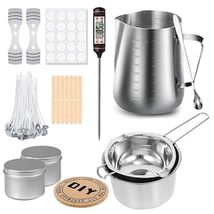May include: A collection of candle-making supplies, including wicks, stickers, a thermometer, a stainless steel pitcher, a double boiler, and small metal tins. A cork coaster with the text "DIY Handmade" is also included.