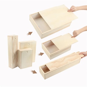 Könnte beinhalten: Holzkisten mit Schiebedeckeln in verschiedenen Größen. Die Kisten sind aus hellem Holz gefertigt und werden in verschiedenen Öffnungsstadien gezeigt. Die Kisten sind rechteckig und haben eine natürliche Holzmaserung.