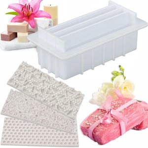 May include: A rectangular white silicone soap mold with a removable lid, accompanied by three rectangular silicone texture mats featuring embossed patterns of bees, roses, and a honeycomb grid, designed for crafting decorative soap bars.