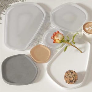 May include: A rustic wooden sign with the text "Welcome to our home" in white lettering. The sign features a distressed finish and a simple, inviting design, perfect for front door decor.