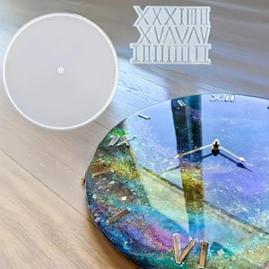May include: A handmade clock with a galaxy-themed resin design. The clock face features gold Roman numerals and hands. A clear, round mold and a Roman numeral mold are also present.