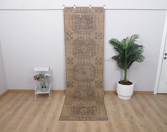 May include: A beige runner rug with a traditional floral pattern. The rug has a distressed look and is made of a soft, durable material.