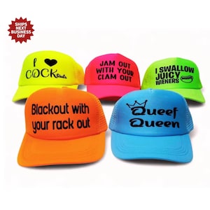 May include: Five brightly coloured trucker hats with black text. The hats feature phrases such as "I Cocktails", "Jam Out With Your Clam Out", and "Queef Queen". Each hat has a mesh back and a curved peak.