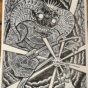 May include: Black and white woodcut print of a monster with large horns and sharp teeth. The monster is surrounded by geometric patterns and lines.