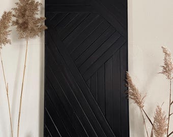 May include: Black geometric wall art made of wood with a modern design. The art piece features a series of intersecting lines and shapes.