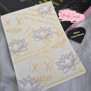 May include: A cream-coloured card featuring grey lotus flower illustrations and text. The card has the text "Every date yourself, I love us for the both of us." and "You taste like my new favorite addiction, baby." A black heart-shaped charm reads "Niko's Lotus Flower."