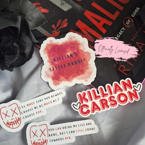 May include: A collection of stickers with text and graphics. One sticker reads "Killian's Little Rabbit" in pink glitter. Another says "Killian Carson" in red. Two stickers feature a mask design with text, including "I'll make sure you always choose me as much as I choose you."