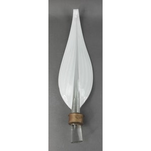 May include: A white glass bottle stopper with a leaf-like design. The stopper has vertical lines and a clear glass stem with a copper-colored band. The overall shape is elongated and elegant, suitable for decorative use.
