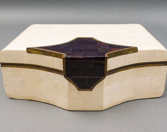 May include: A white bone inlay box with a dark purple and brass inlay design on the top.