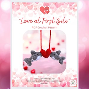 May include: A PDF crochet pattern titled "Love at First Bite" featuring two gray crocheted sharks facing a red crocheted heart. The pattern includes instructions for creating the sharks and heart, perfect for Valentine's Day or a romantic gift.