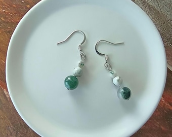 May include: A pair of silver dangle earrings with green and white agate beads. The earrings have a simple hook closure.