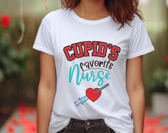 May include: White t-shirt with the text "Cupid's favorite nurse" in red and blue lettering. A red heart with a blue arrow is below the text.