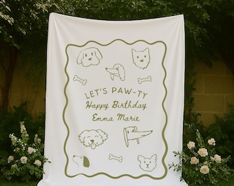 May include: White blanket with a green border and dog illustrations. The text "LET'S PAW-TY Happy Birthday Emma Marie" is printed in green. The blanket is displayed outdoors on a green lawn.