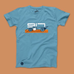 May include: A light blue t-shirt with a white and orange graphic of a race car with the number "917" printed on it. The text "Classic Original" is printed on the shirt.