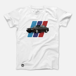 May include: White t-shirt with a black BMW E34 sedan printed on the front. The car is surrounded by three stripes in blue, dark blue, and red.