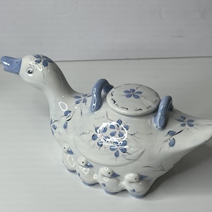 May include: A set of three ceramic mugs with a speckled, matte finish. The mugs are in shades of cream, light gray, and dark gray. Each mug has a simple, minimalist design, perfect for coffee or tea. The mugs are stacked on top of each other.