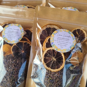 May include: Clear cellophane bags filled with dried lemon slices, herbs, and a floral label that reads "Lemon Lavender Stovetop Simmer Potpourri". The bags are sealed and ready for use.