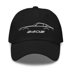 May include: Black baseball cap with a white embroidered outline of a classic sports car and the number "240Z". The cap has a curved peak and an adjustable strap for a comfortable fit.