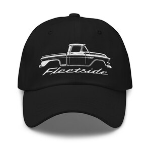 May include: Black baseball cap featuring a white outline of a classic pickup truck with the word "Fleetside" in a stylized font. The cap has a curved brim and a button on top, suitable for casual wear.