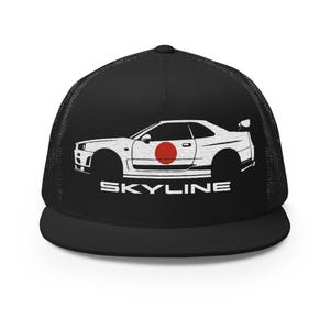 May include: Black trucker hat featuring a white outline of a car with a red circle on the side. The word "SKYLINE" is printed in white below the car. The hat has a black mesh back and a curved brim.