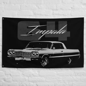 May include: Black wall flag with a white illustration of a classic '64 Impala car. The car is shown in profile, with details like headlights and wheels visible. Above the car, the text '64 Impala' is displayed in a stylized font.