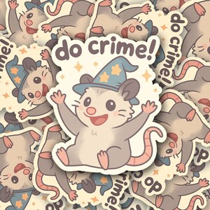 May include: A collection of stickers featuring a cartoon opossum wearing a wizard hat with stars. The opossum is light gray with a pink tail and is smiling with its arms raised. The text "do crime!" is above the opossum.