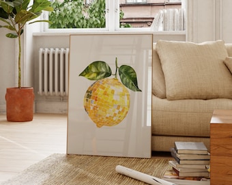 May include: A framed print of a watercolor painting of a lemon with a disco ball texture. The lemon is yellow with green leaves and is set against a white background.