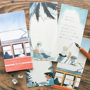 May include: A collection of illustrated postcards featuring watercolor artwork. The cards depict scenes of people reading, a tram, and a seaside setting. The color palette includes blues, oranges, and greens. Some cards have handwritten text.