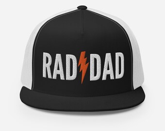 May include: Black and white trucker hat with a white embroidered lightning bolt and the text "RAD DAD" in white.