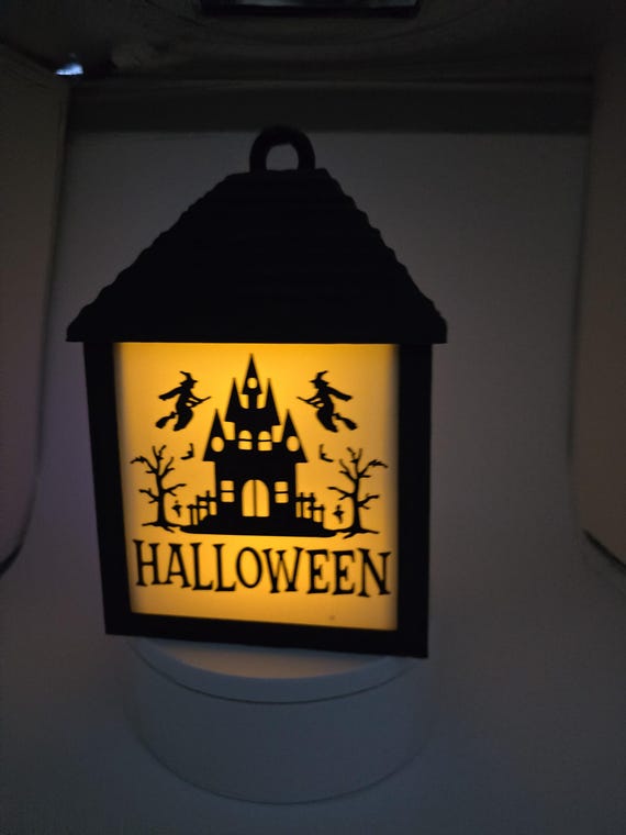 Halloween lantern with changeable "window pane" designs