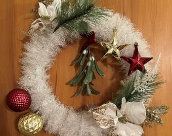 Embrace the festive spirit with the Christmas Joyeux Noel Wreath Complemented by burgundy and gold ornaments.