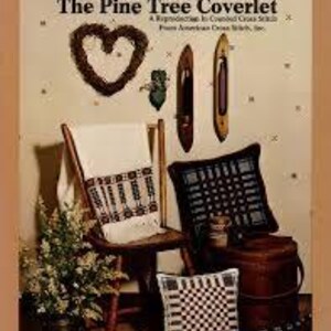 May include: An image of a collection of handcrafted items. A wooden chair holds a white towel with a geometric pattern. A black pillow with a woven design sits next to a small brown barrel. A heart-shaped wreath and two wooden shuttles are mounted on the wall.
